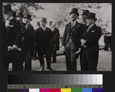 Groupe d'hommes avec chapeau haut-de-forme à l'occasion d'une cérémonie non identifiée. On reconnaît à droite de l'image le Professeur Rosselet, avec les mains croisées devant lui, avec à ses côtés le Professeur Pierre Decker.