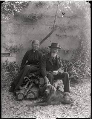 Portrait d'un homme et d'une femme âgés assis sur des troncs d'arbre. Ce sont vraisemblablement les parents du docteur Eugène Olivier.